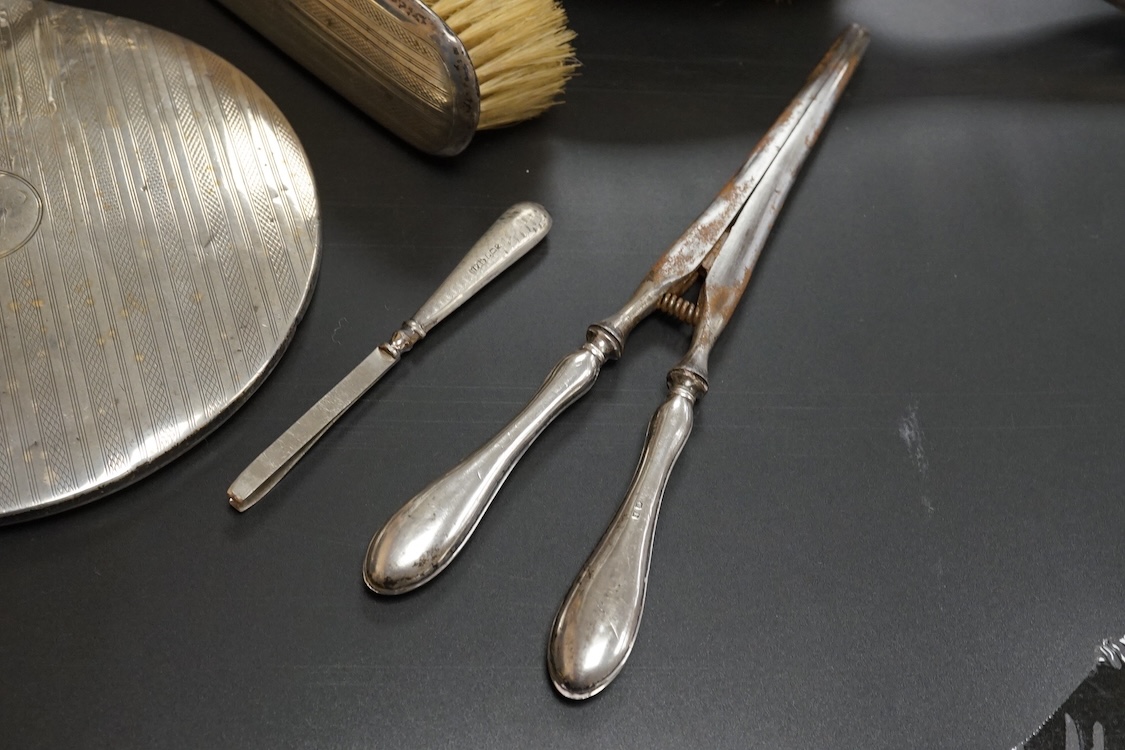 Ten assorted silver mounted dressing table items, including brushes, hand mirror, manicure items and glove stretchers.